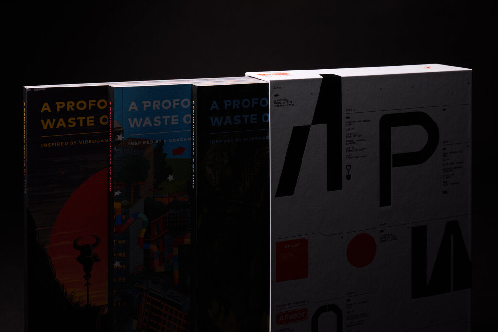 A dramatically lit trilogy collection of A Profound Waste of Time. Issues 1, 2 and 3 are slipping out of the trilogy slipcase. Slipcase designed by Lundqvist. Issue 1 featuring Shovel Knight, Issue 2 featuring Keita Takahashi and Issue 3 featuring Fumito Ueda.