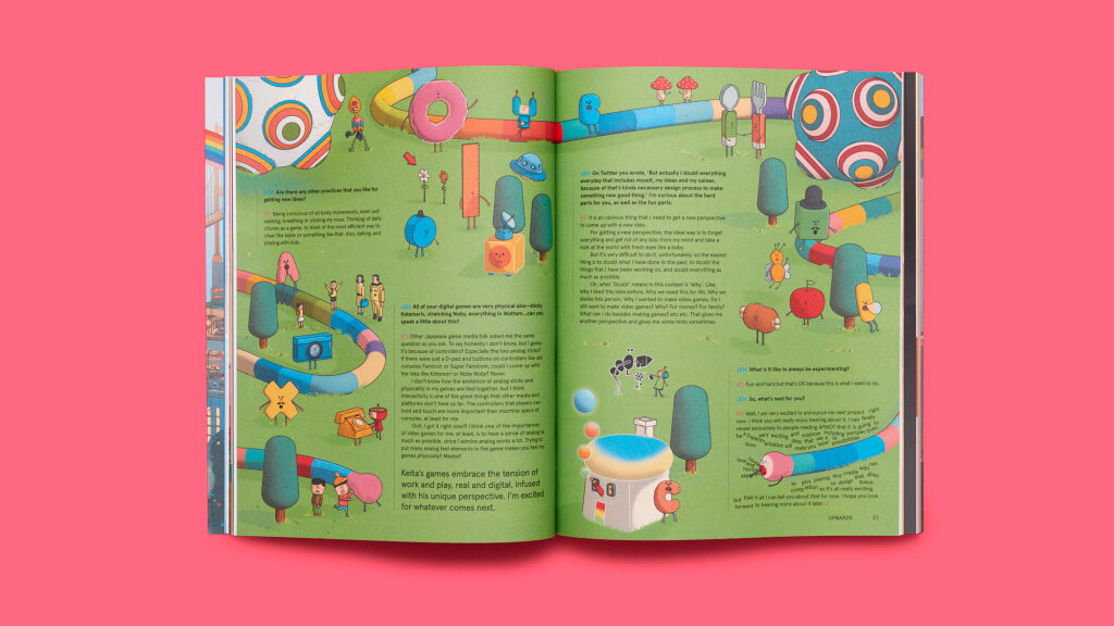 Full magazine spread from Issue 2 of A Profound Waste of Time showing Keita Takahashi's characters on a green field. Noby Noby Boy is eating the last few words on the page.